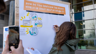 woman writing on a board reuse plastic